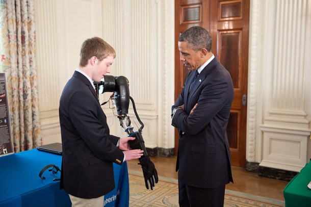 LaChapelle showing his robotic prosthesis to Obama