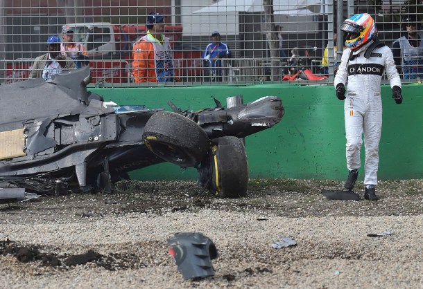 McLaren driver Fernando Alonso of Spain looks back at his wrecked car after he collided with Haas driver Esteban Gutierrez of Mexico during the Australian Formula One Grand Prix at Albert Park in Melbourne, Australia, Sunday, March 20, 2016. (AP Photo/Theo Karanikos)
