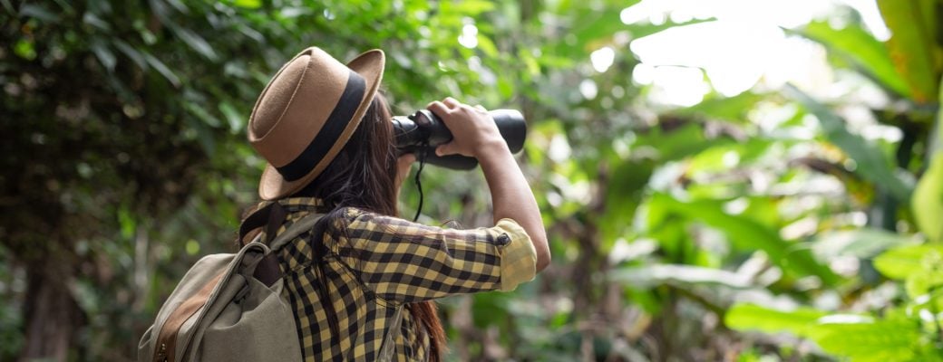 explorador-turista-selva-prismáticos-observar